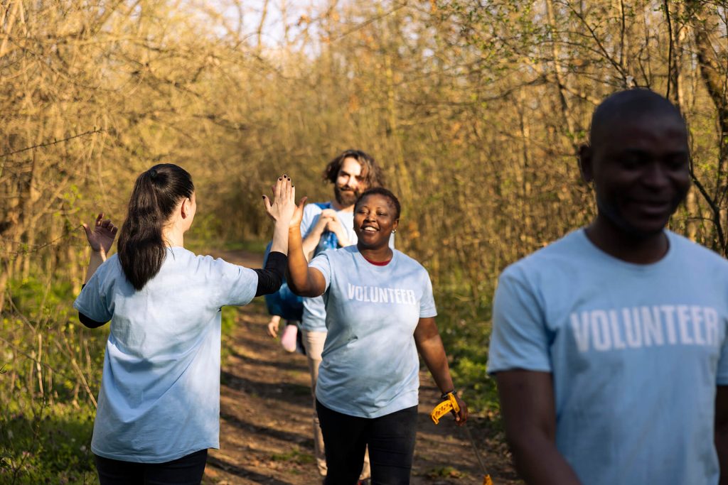 joyful group of environmentalists doing high five
